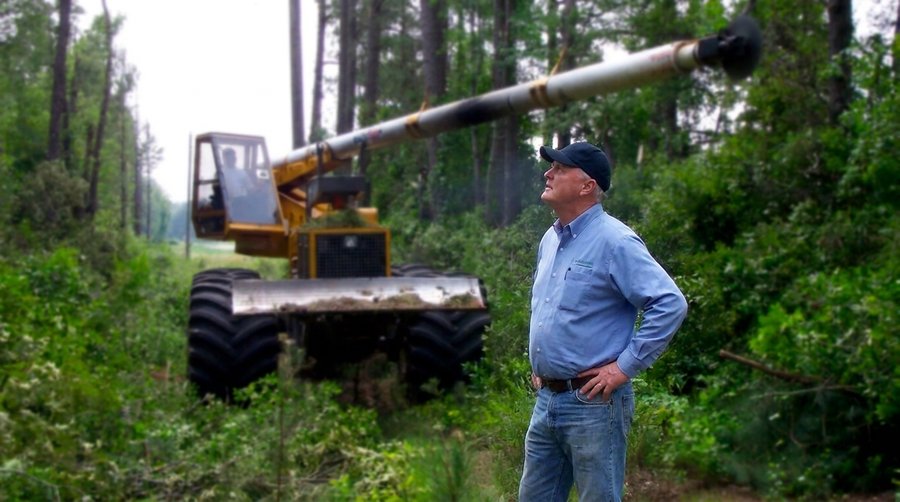 John Olson checking on right-of-way clearing equipment at his commercial tree company